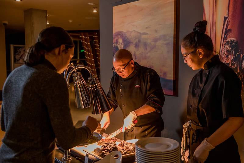 Red Seal Executive Chef David Li serves Braised Bison Short Ribs with apprenticing cook Jocelyn Gabriel, Lil’wat Nation.