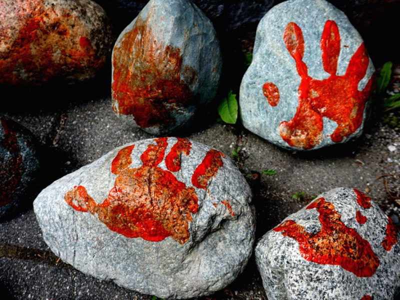 Rocks featuring painted hand prints