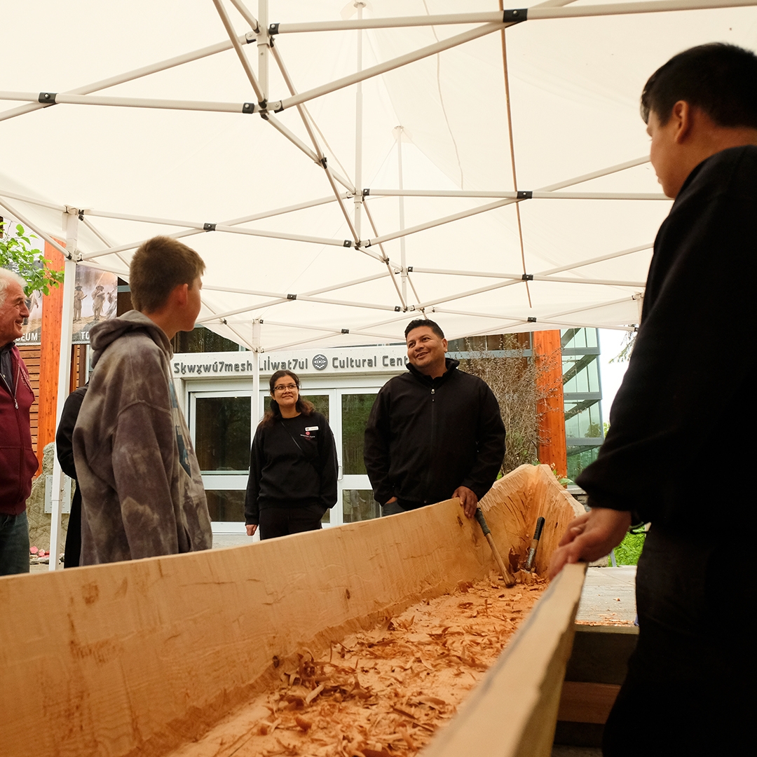 Master Carver Ray Natraoro and Apprentice carver Brandon Hall with the Community Reconciliation Canoe