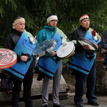 Squamish Canoe Family performing as part of the Log Blessing for the SLCC Community Reconciliation Canoe: From left Victor Khatsalano, Calvin Charlie-Dawson, Ray Natraoro