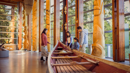 Family exploring carvings at the Squamish Lil'wat Cultural Centre