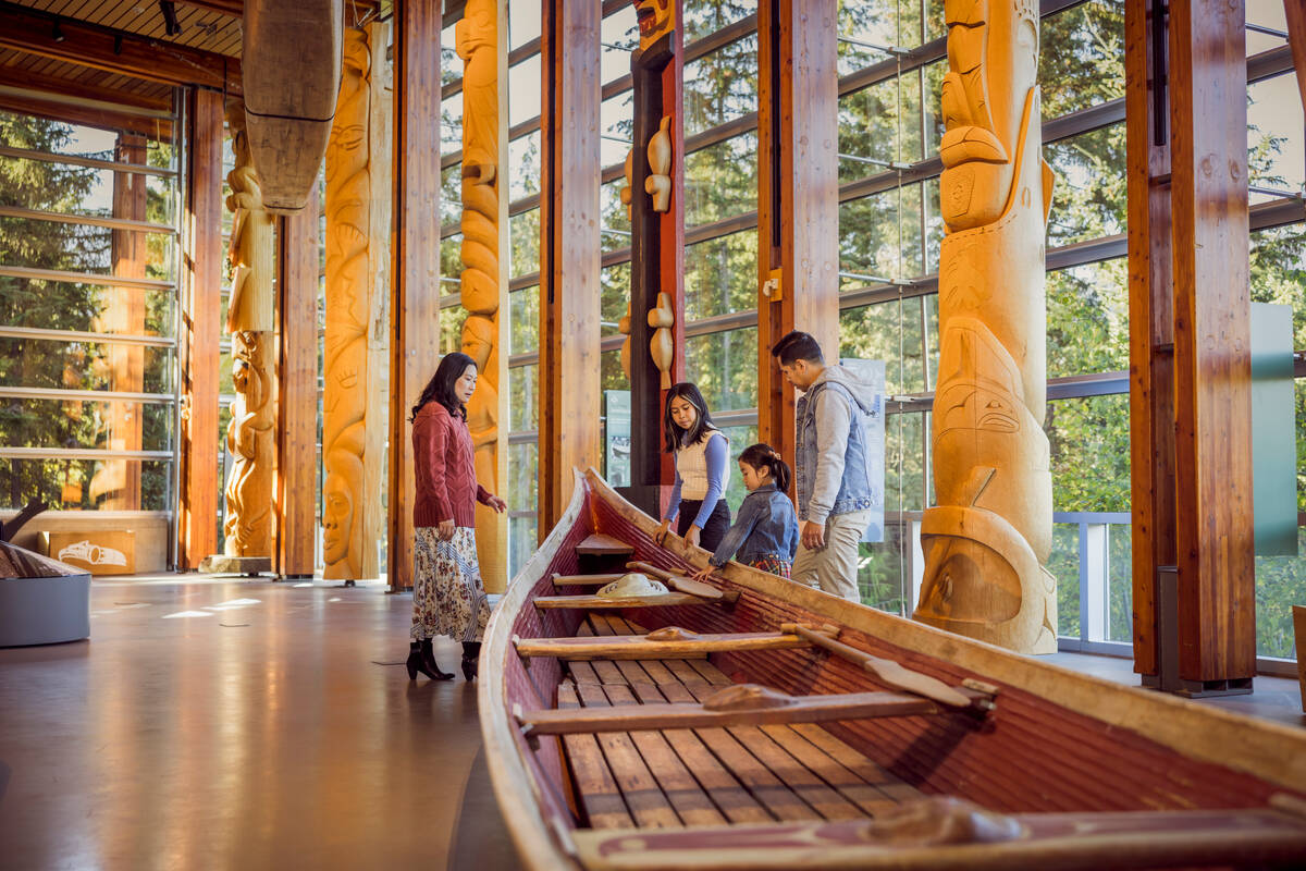 Family exploring carvings at the Squamish Lil'wat Cultural Centre