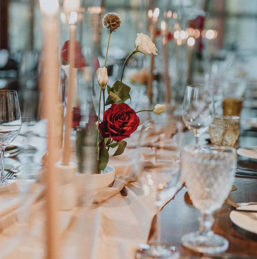 Elegant wedding table decor with candles and florals arranged by local partners at the Squamish Lil’wat Cultural Centre in Whistler