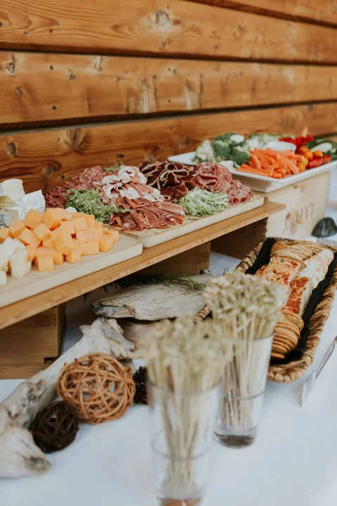 Elegant wedding appetizer platter with cheeses, cured meats, and fresh vegetables at a Whistler venue.