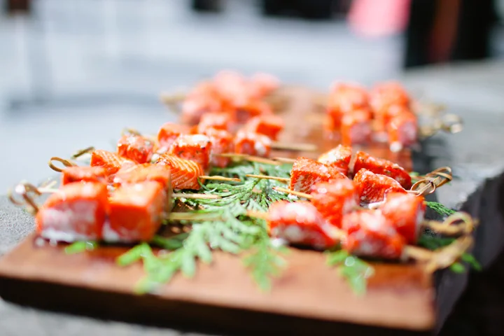 Delicious salmon skewers garnished with fresh herbs, displayed as appetizers for a wedding in Whistler.