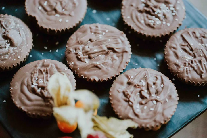Close-up of homemade chocolate cups or peanut butter cups with sea salt, displayed as wedding desserts in Whistler.
