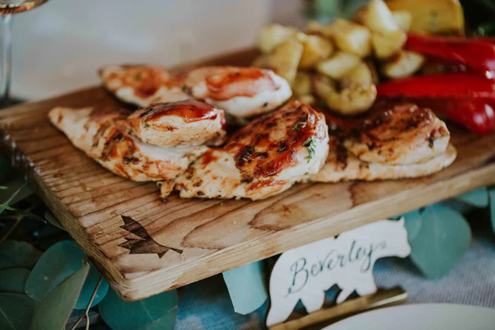 Close-up of a beautifully plated grilled chicken entree with roasted potatoes and vegetables for a Whistler wedding.